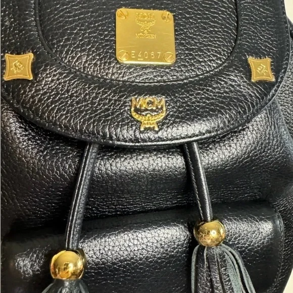 MCM Gold Studded Logo Black Pebbled Leather Backpack Tasseled Drawstring - Picture 2 of 15